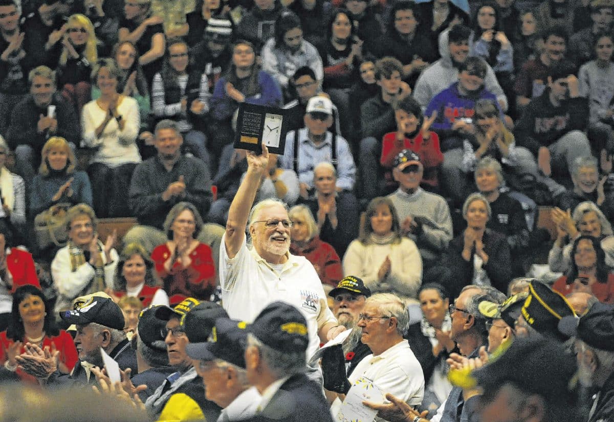 Local Vietnam veteran Hank Marshall shows off his commemorative gift from the Brown County High School History Club during the annual Veterans Day program in the Larry C. Banks Memorial Gymnasium on Nov. 11. The History Club presented Marshall with the gift after it was announced that Marshall was recently inducted to the Indiana Military Veterans Hall of Fame. Marshall joins the ranks of well-known Hoosier veterans, like wartime journalist Ernie Pyle and the 23rd president of the United States, Benjamin Harrison, who have also been inducted. Suzannah Couch | The Democrat