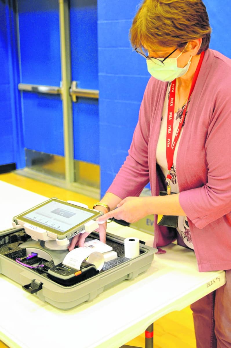 Brown County Clerk Kathy Smith demonstrates how to scan an ID with the new electronic pollbooks that will be used for voting this year.