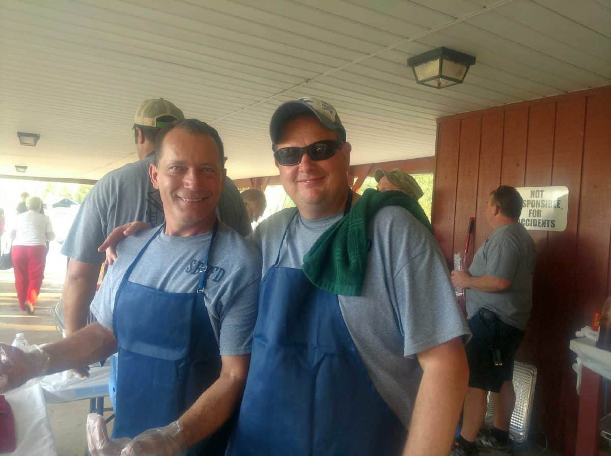 Volunteer firefighters William Newman, left, and Tim True serve food at the Southern Brown Volunteer Fire Department cookout in this Oct. 14, 2017 file photo. File photo