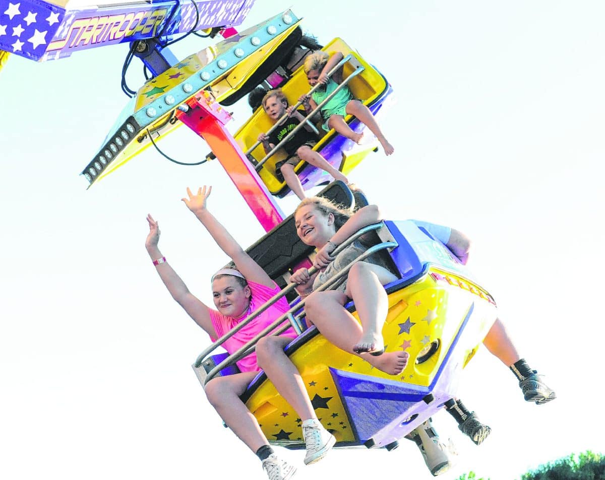 Aryn Fish, right, and Lainey White enjoy a ride on the Star Trooper at the Brown County Fair. Suzannah Couch | The Democrat