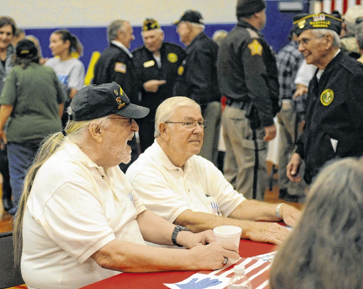 Local Vietnam veteran Hank Marshall, far left, visits with other vets before the annual Veterans Day program in the Larry C. Banks Memorial Gymnasium on Nov. 11. Marshall was recently inducted to the Indiana Military Veterans Hall of Fame. Marshall joins the ranks of well-known Hoosier veterans, like wartime journalist Ernie Pyle and the 23rd president of the United States, Benjamin Harrison, who have also been inducted. Suzannah Couch | The Democrat