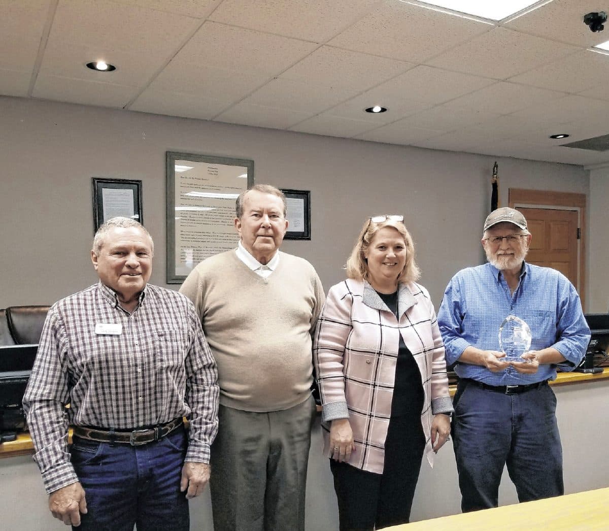 Brown County Commissioners Jerry Pittman, Dave Anderson and Diana Biddle pose for a photo with Brown County Highway Superintendent Mike Magner, far right, after Magner received an award for his service to the county.   Suzannah Couch | The Democrat