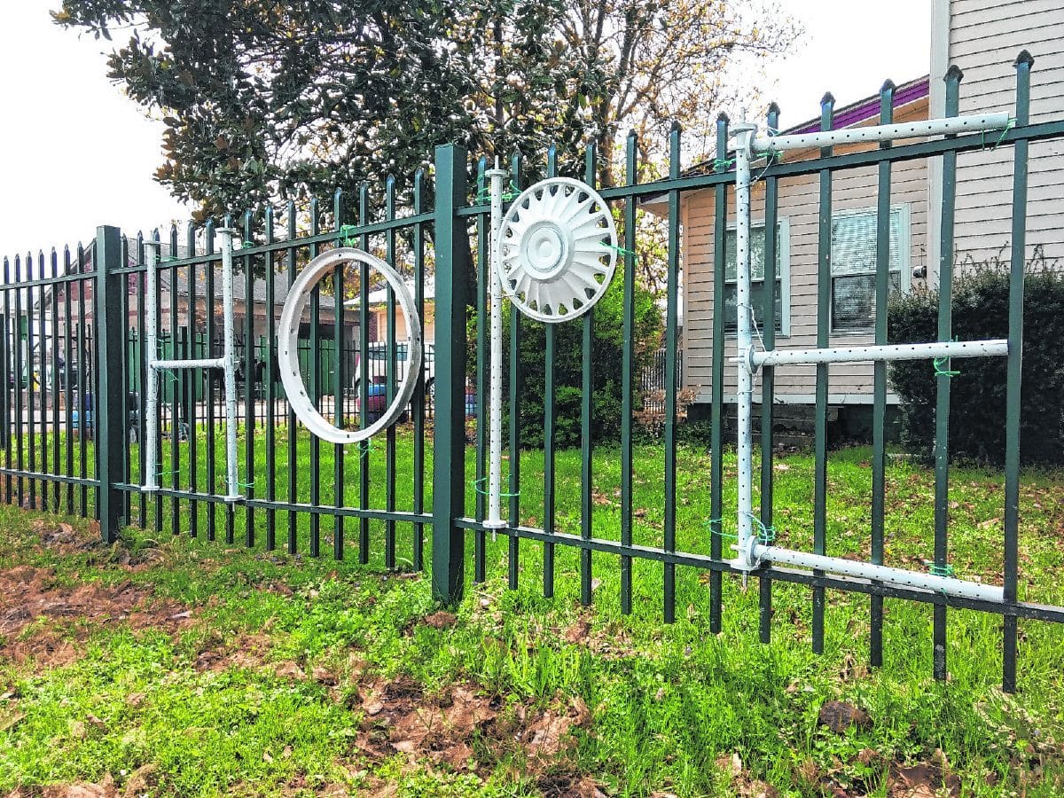 Nancy Crocker redecorated the fence outside her Olde Magnolia House Inn with a message of hope. She also plans to add blue lights as a nod to the work of emergency responders during the COVID-19 pandemic.  Sara Clifford | The Democrat