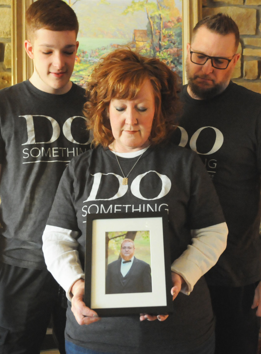 From left to right: Hudson, Michelle and Cory Joy look down at a photo of Caleb Joy, Michelle and Cory’s oldest son in this 2018 Brown County Democrat file photo. Caleb passed away from an overdose in 2017. Caleb’s death started the “Do Something” movement in Brown County with loved ones of those suffering from substance use disorder and those who are in recovery coming together to find support and inspiration.